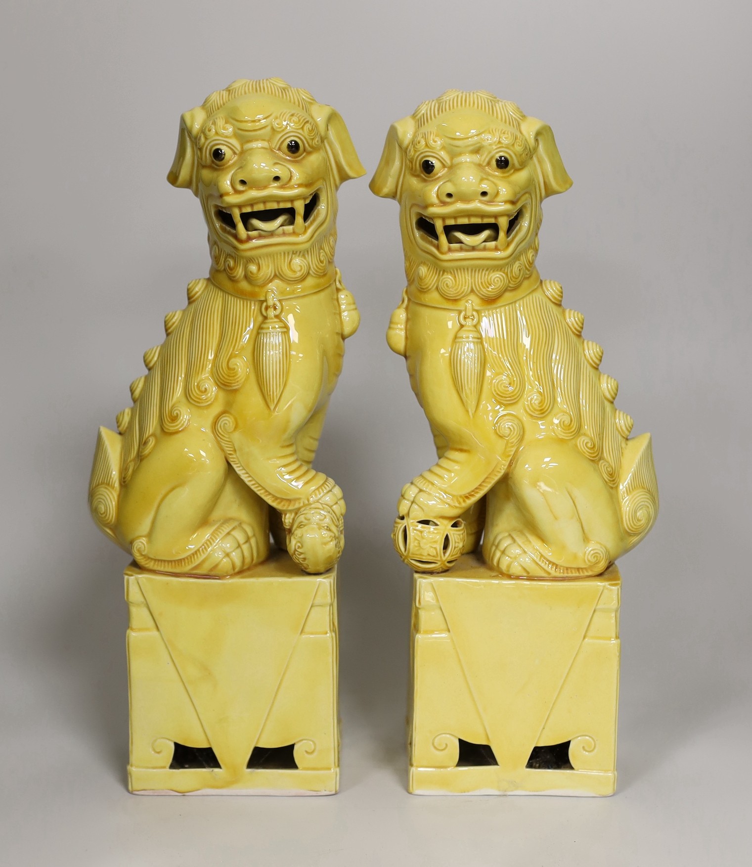 A pair of Chinese yellow glazed temple lion dogs 30cm
